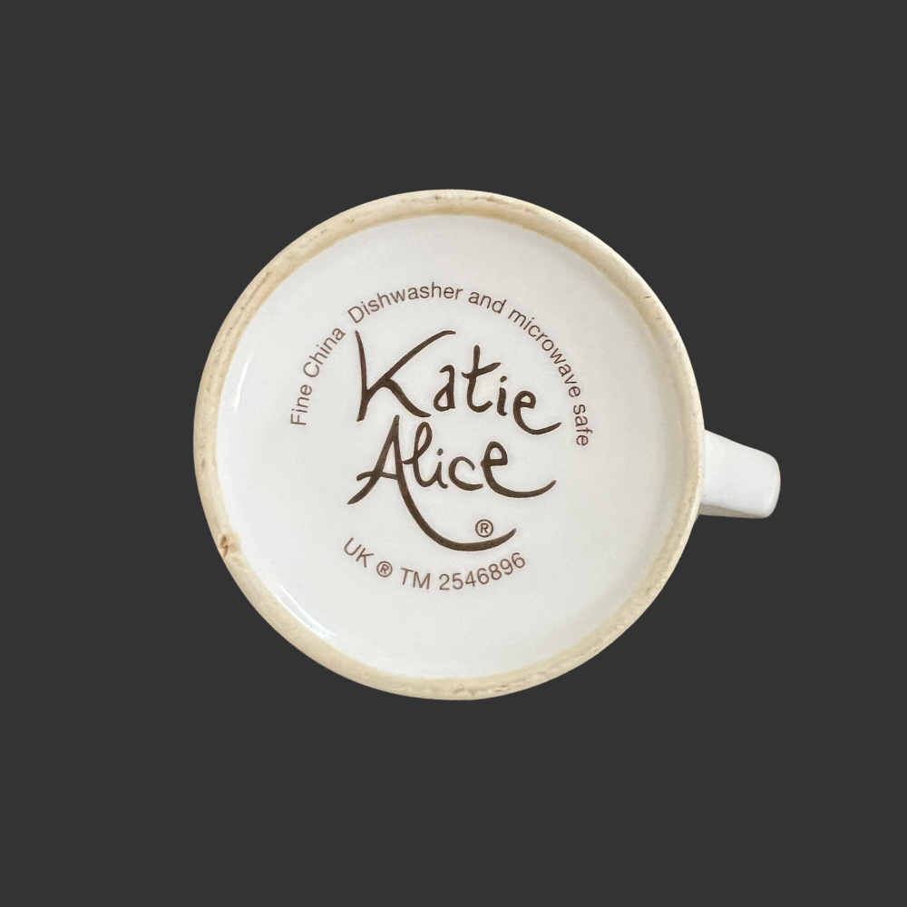 Katie Alice mug with branding on a black background