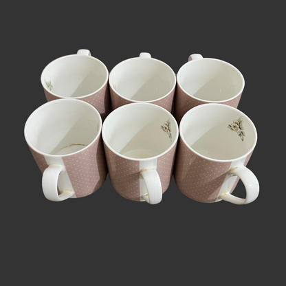 Set of six ceramic mugs with floral patterns on a dark background